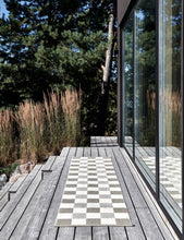 Load image into Gallery viewer, dark linen and cream checkered rug on a wooden deck