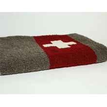 Load image into Gallery viewer, Brown throw with a red stripe and a white plus sign in the red stripe folded up on a white space