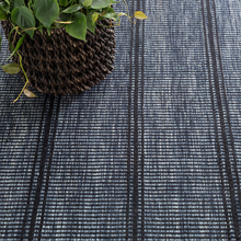 Load image into Gallery viewer, Navy rug with plant on top