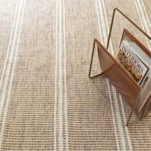Load image into Gallery viewer, Natural rug with a leather magazine holder with books in it