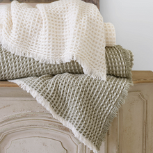 Load image into Gallery viewer, Plaster blanket and sage blanket stacked on a wooden counter