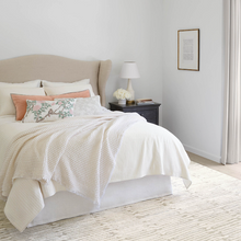 Load image into Gallery viewer, Plaster blanket on bed setting in a white bedroom with a bedside table and rug