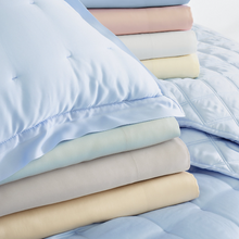 Load image into Gallery viewer, different colored sheets on a blue bed setting