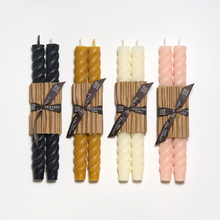 Load image into Gallery viewer, The black taper candles to the left and the cream are the third in the line