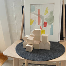 Load image into Gallery viewer, Stacked wooden houses with a unique artpiece in the background