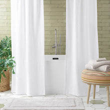 Load image into Gallery viewer, Bathroom with a white tub and a grey bathmat on a beautiful tile floor