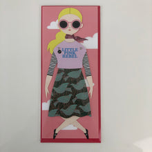 Load image into Gallery viewer, Blonde doll with sunglasses, a "Little pink rebel" shirt, and crossing her legs in a curtsy.
