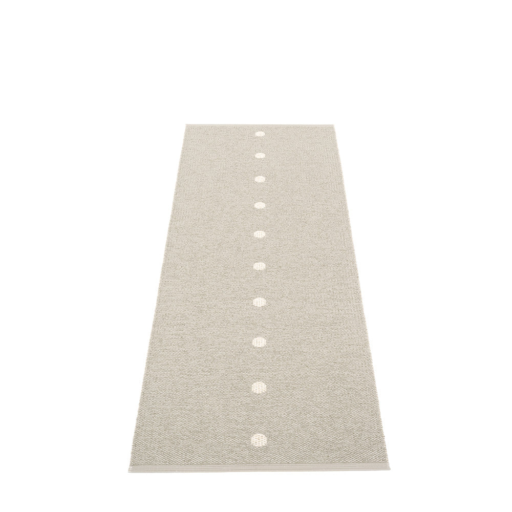 grey peg rug with small white dots on a white floor