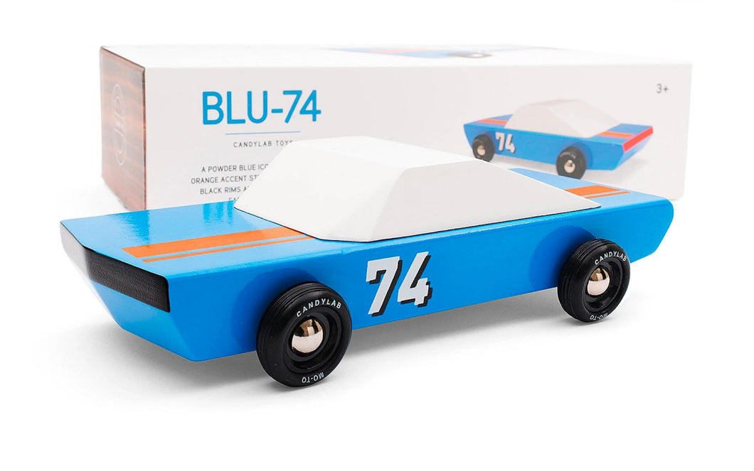 A blue stockcar with white top, black wheels, and number 74 on the door.  The product box is in the background. 