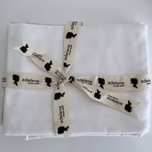 Load image into Gallery viewer, ribben holding the folded white bedding