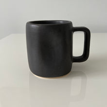 Load image into Gallery viewer, Close up of the black Alex Marshall mug