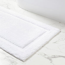 Load image into Gallery viewer, White bath mat on a marble floor
