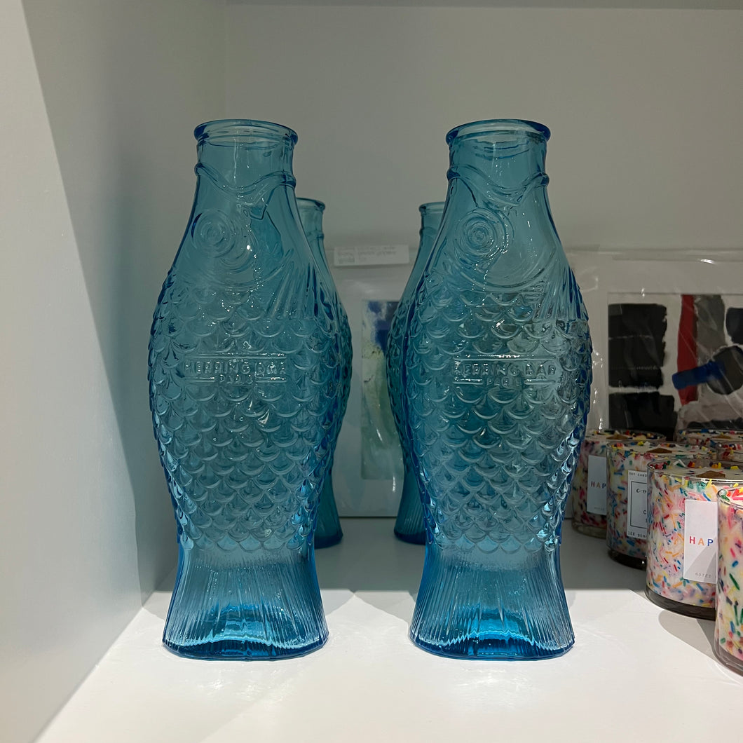 two roys of the fish carafes on a shelf