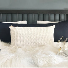 Load image into Gallery viewer, navy blue lumbar pillow on a bed with white bedding
