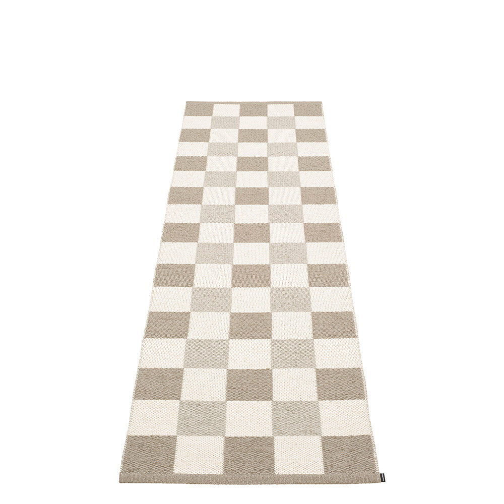 cream and dark linen checkered rug on a white floor
