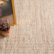 Load image into Gallery viewer, close up view of the white and wicker rug pattern with a flower and a painting on the rug
