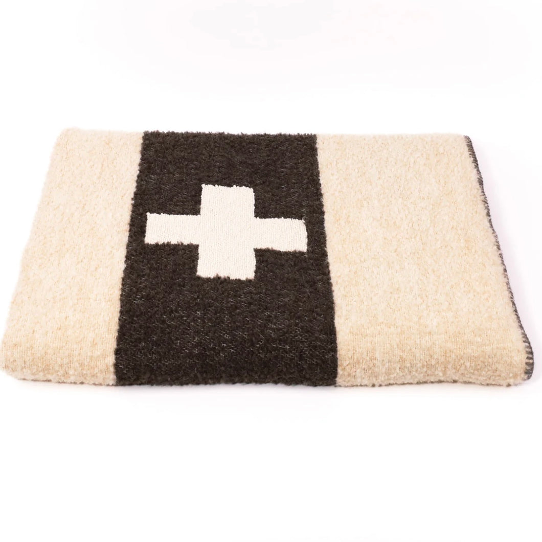 Cream blanket with a grey stripe and a white plus sign in the grey stripe folded up on a white background