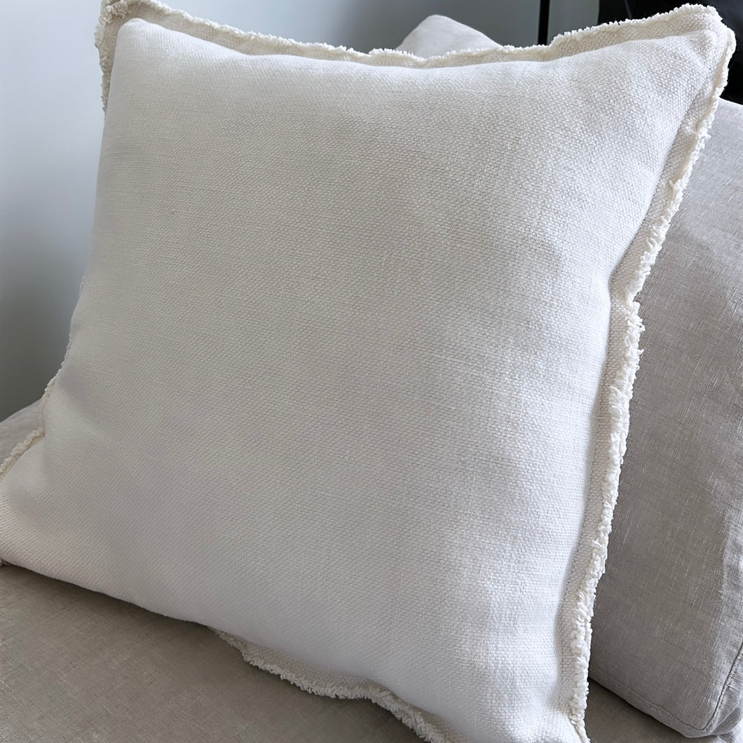 white pillow on a grey couch