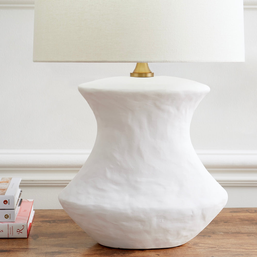 White matte table lamp on a wooden shelf