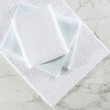 Load image into Gallery viewer, grey bath mat with towels folded on top of it
