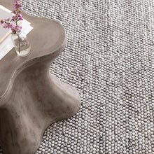 Load image into Gallery viewer, grey rug with a unique grey table and flower on top
