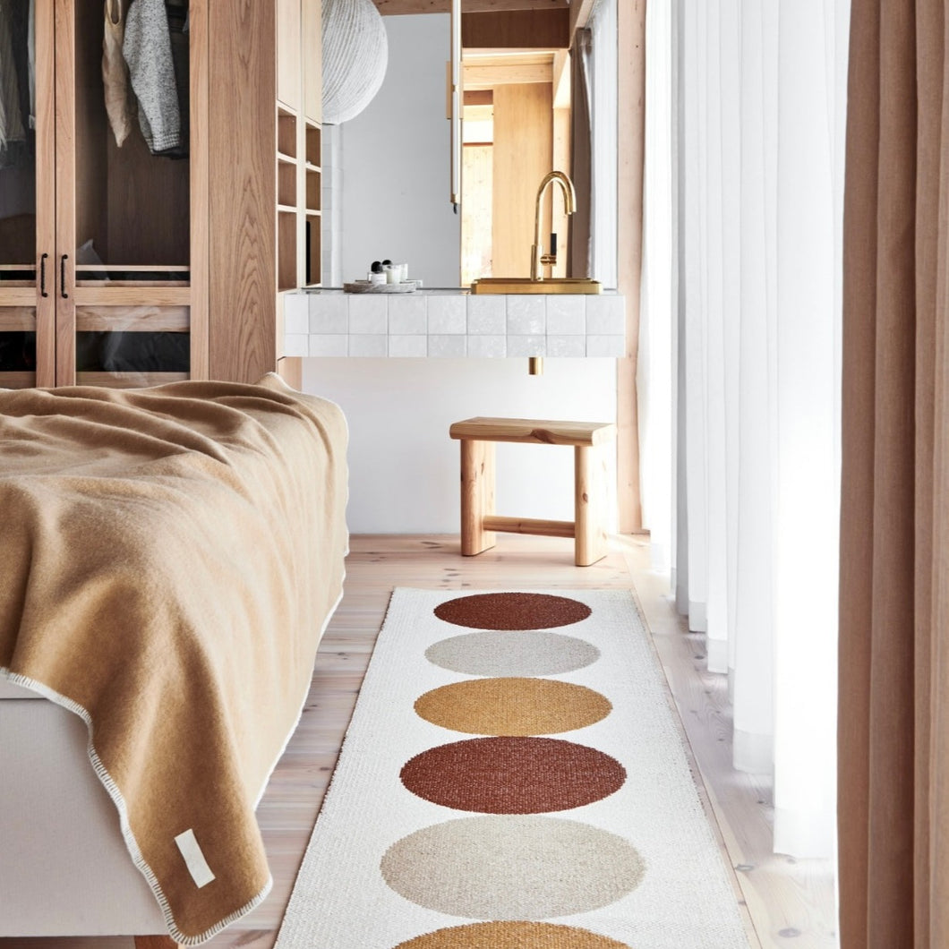 beautiful otto harvest rug on the cream side in a bedroom scene