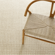 Load image into Gallery viewer, Natural rug with a rattan chair on top
