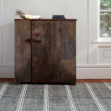 Load image into Gallery viewer, Black/ivory rug with a wooden cabinet on it
