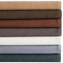 Load image into Gallery viewer, All the colored throws folded and stacked on top of one another
