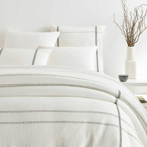 Grey duvet cover on a bed setting