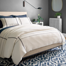 Load image into Gallery viewer, Navy duvet cover on a darker bed setting 
