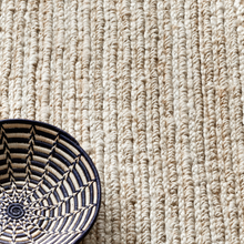 Load image into Gallery viewer, Bleached rug with a woven black and white basket on it
