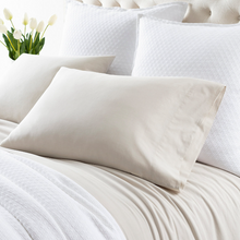 Load image into Gallery viewer, natural sheets on a white bed setting
