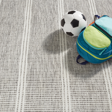 Load image into Gallery viewer, grey rug with a backpack and soccer ball on it

