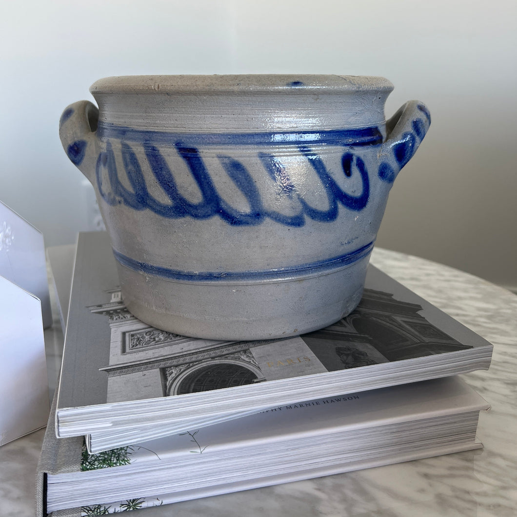 grey and blue antique ceramic pot on coffee table books