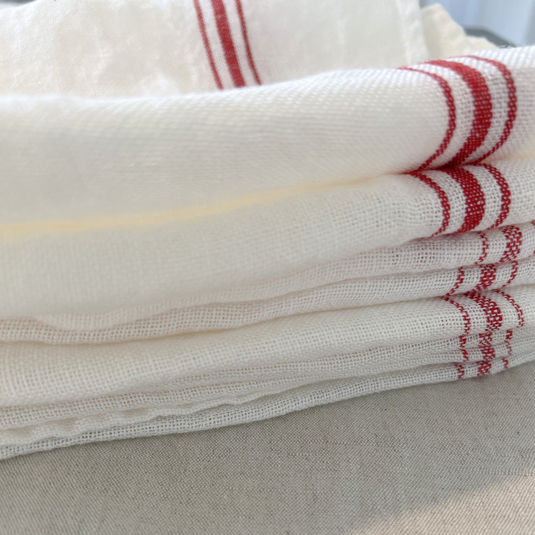 stack of white and red libeco tea towels
