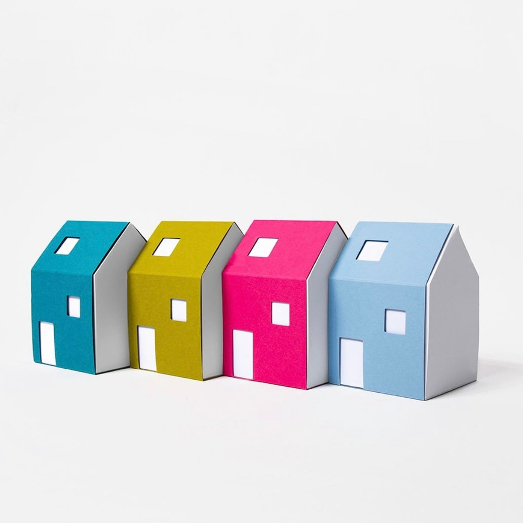 four house notepads in a row (blue, green, pink, light blue) on a white background