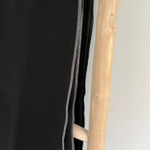 Load image into Gallery viewer, Black throw with a grey edge on a wooden blanket ladder
