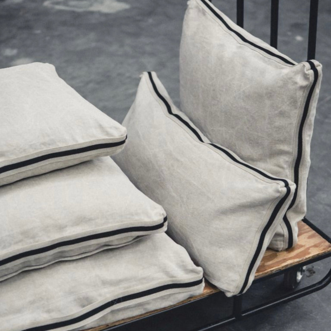 libeco cream and black pillows on a roller cart