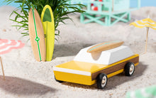 Load image into Gallery viewer, Yellow and wooden toy car from Candylab on the beech with surfboards
