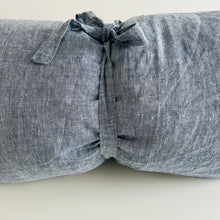 Load image into Gallery viewer, Solid blue pillow wrapped up with a ribbon around it 
