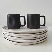 Load image into Gallery viewer, Black Alex Marshall mugs on white dinner plates
