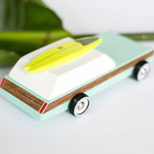 Load image into Gallery viewer, posterior view of the wagon with the surfboard on top 
