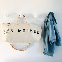 Load image into Gallery viewer, Des Moines bag and jean jacket hanging on the dropit tooks
