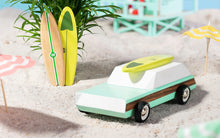 Load image into Gallery viewer, green wooden wagon on a beach scene
