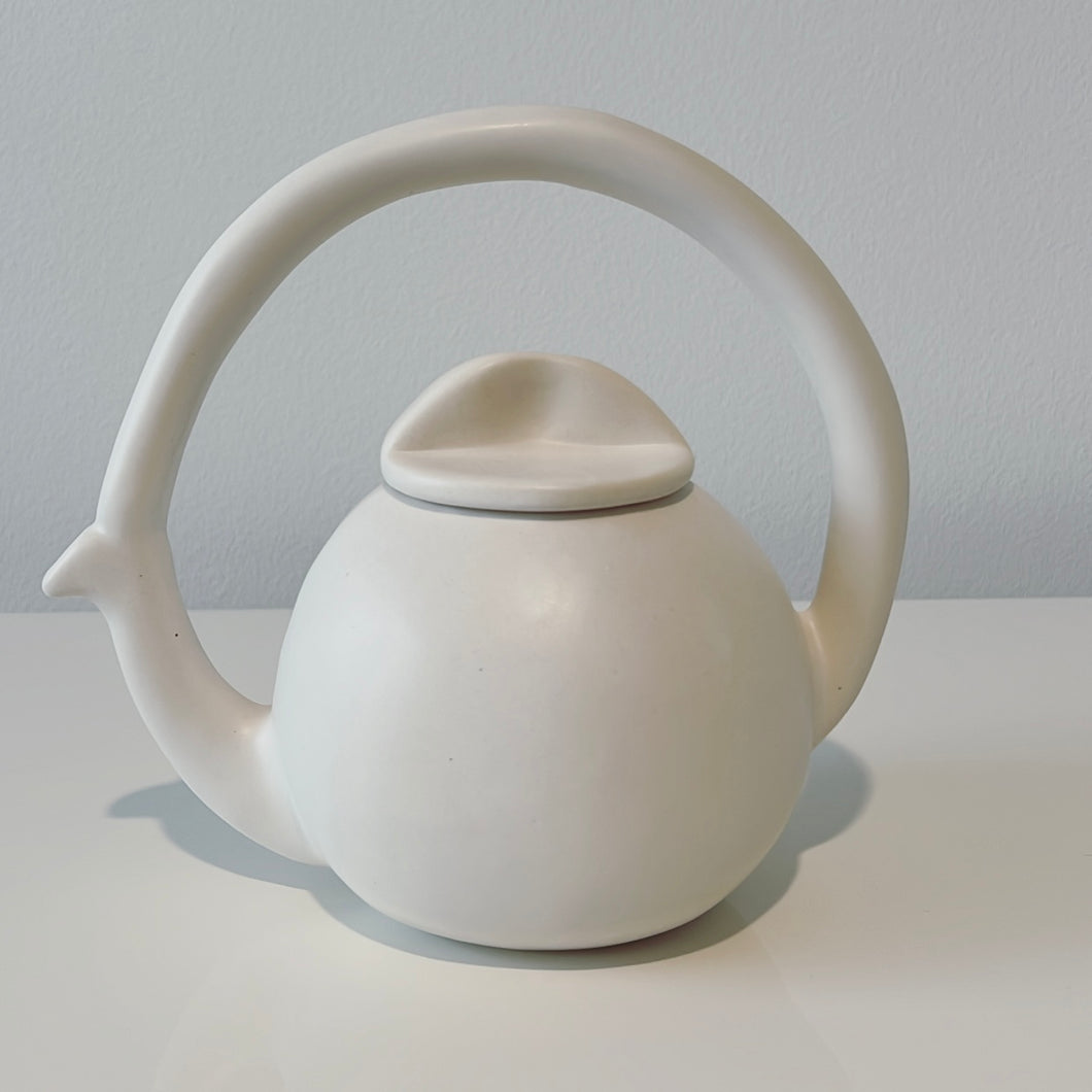 White Alex Marhsall ceramic tea pot on a white surface