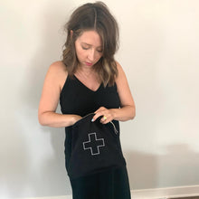 Load image into Gallery viewer, model holding the black linen bag with a white plus sign in the middle
