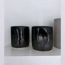 Load image into Gallery viewer, Shiny black tumbler from Alex Marshall on a white shelf
