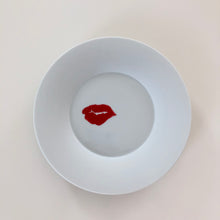 Load image into Gallery viewer, kiss plate on a white shelf
