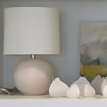Load image into Gallery viewer, cream table lamp on a shelf next to a few vases and artwork
